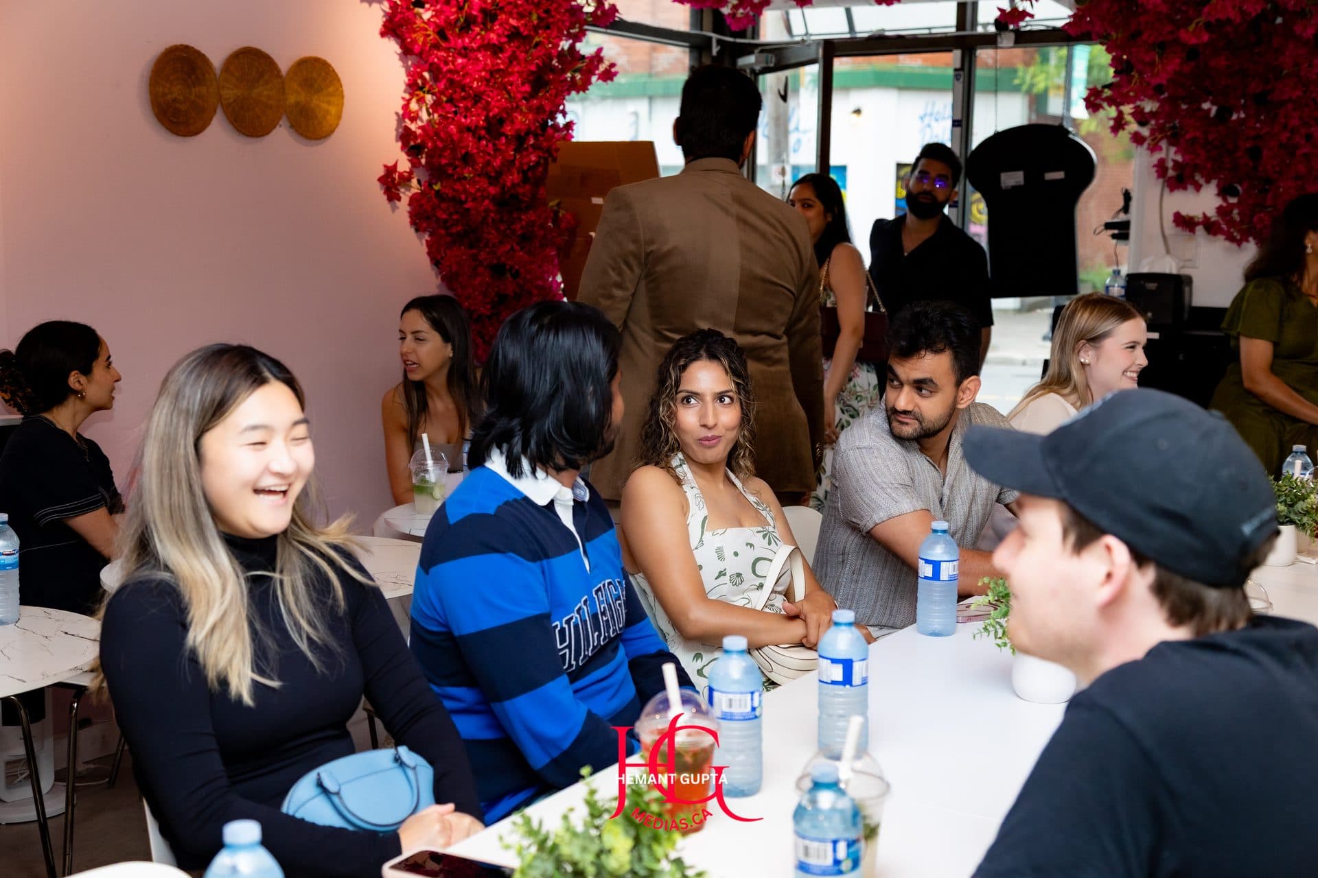A group of guests laughing together at a table during Preview Night