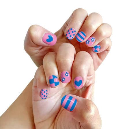 A pair of hands with nails painted in pink and blue patterns