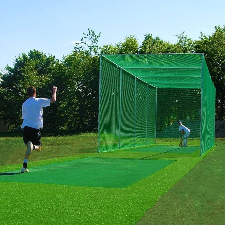 Two players using a portable cricket batting cage outdoors
